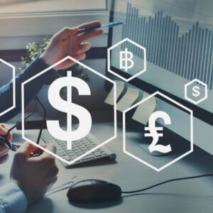 currency symbols over a photo of a desk with computer.