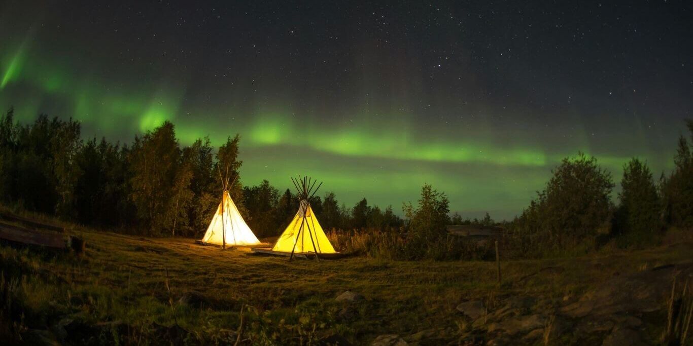 Tents on Green Field Under Aurora Borealis