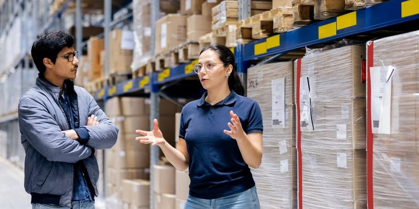 Warehouse-workers-discussing-supply-chain-management (1) Warehouse workers discussing on supply chain management