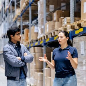 Warehouse workers discussing on supply chain management